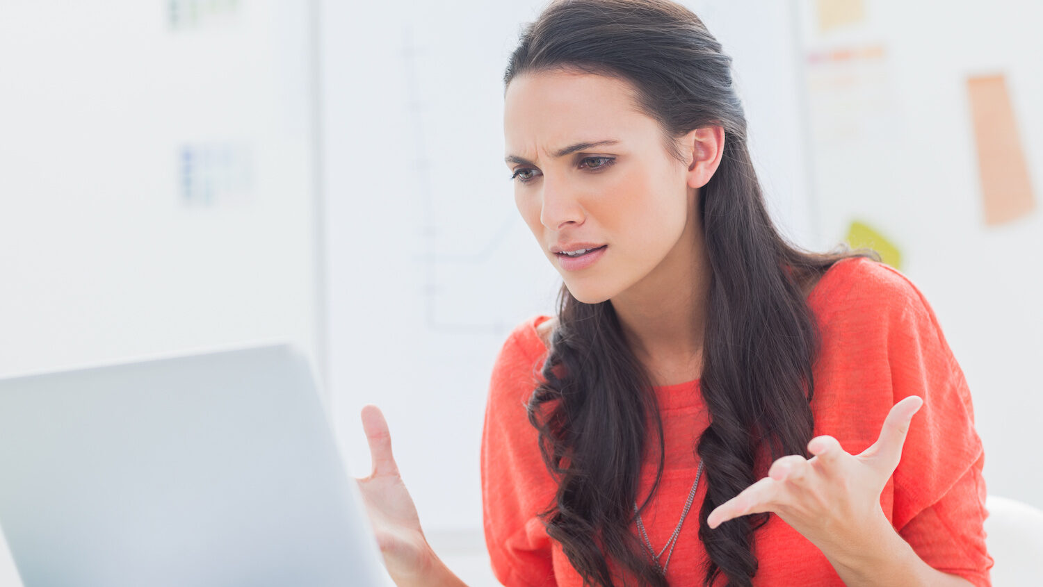 woman annoyed at laptop