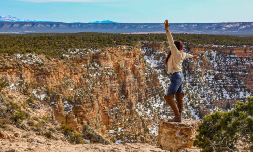 girl stands at the Grand Canyon