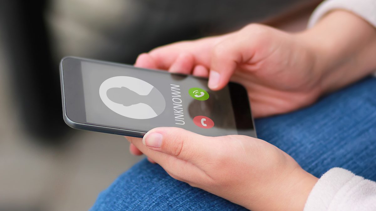 Close up of hands holding phone with unknown caller