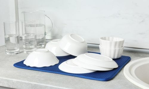 Different clean plates near sink in kitchen