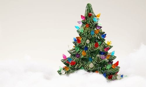 Ceramic Christmas tree surrounded by fake snow