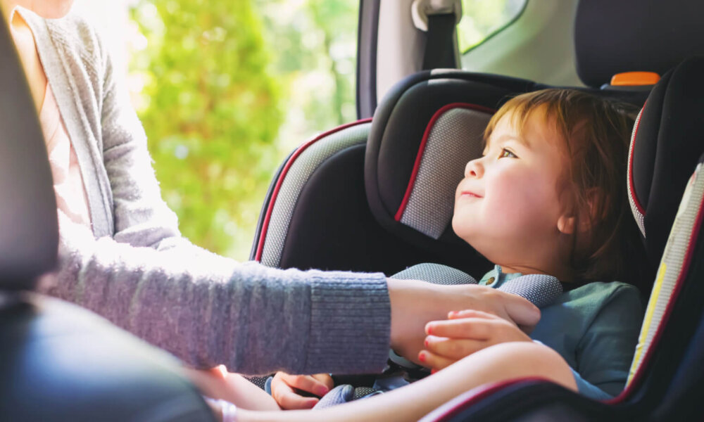 Toddler girl buckled into her car seat