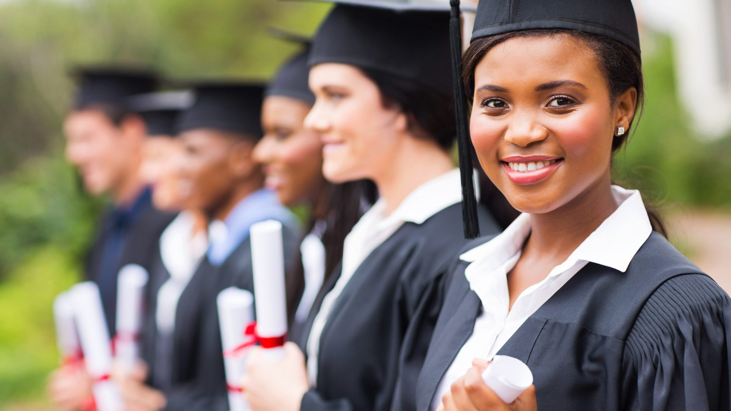 College students hold diplomas