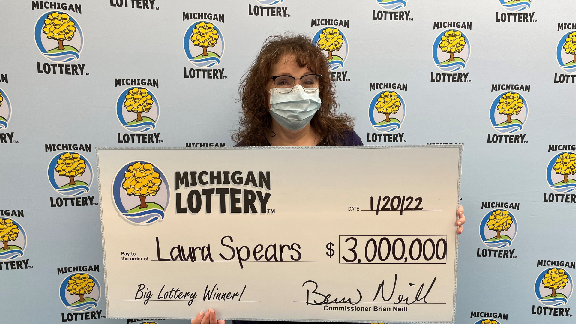 Laura Spears holds Michigan Lottery check