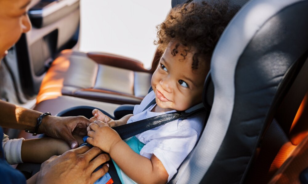 Cute baby smiles in car seat