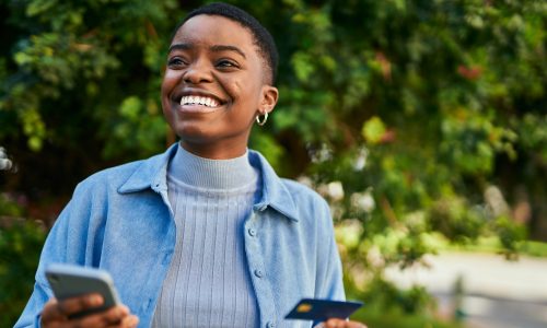 Smiling woman uses credit card