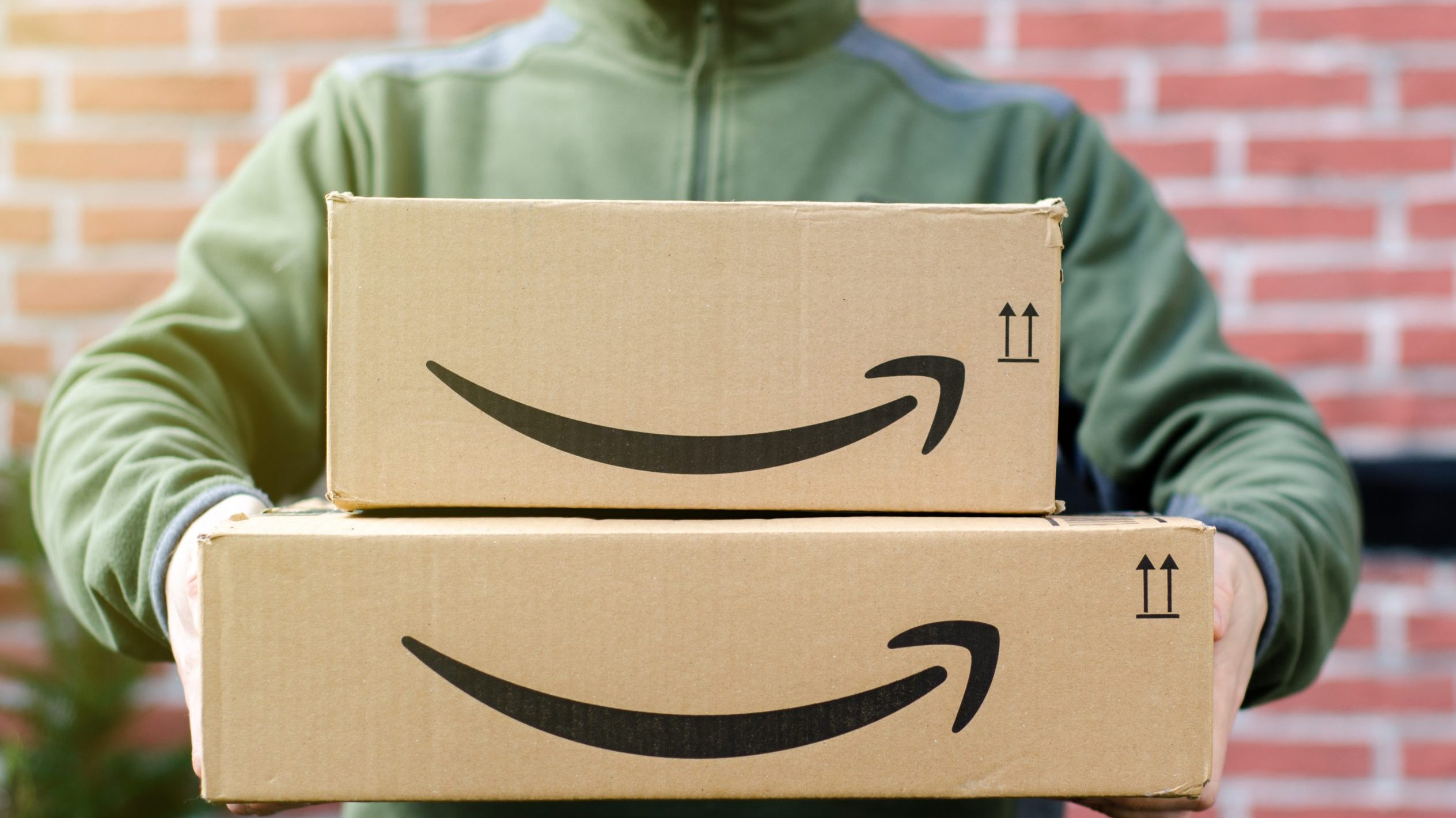 Man holds Amazon boxes