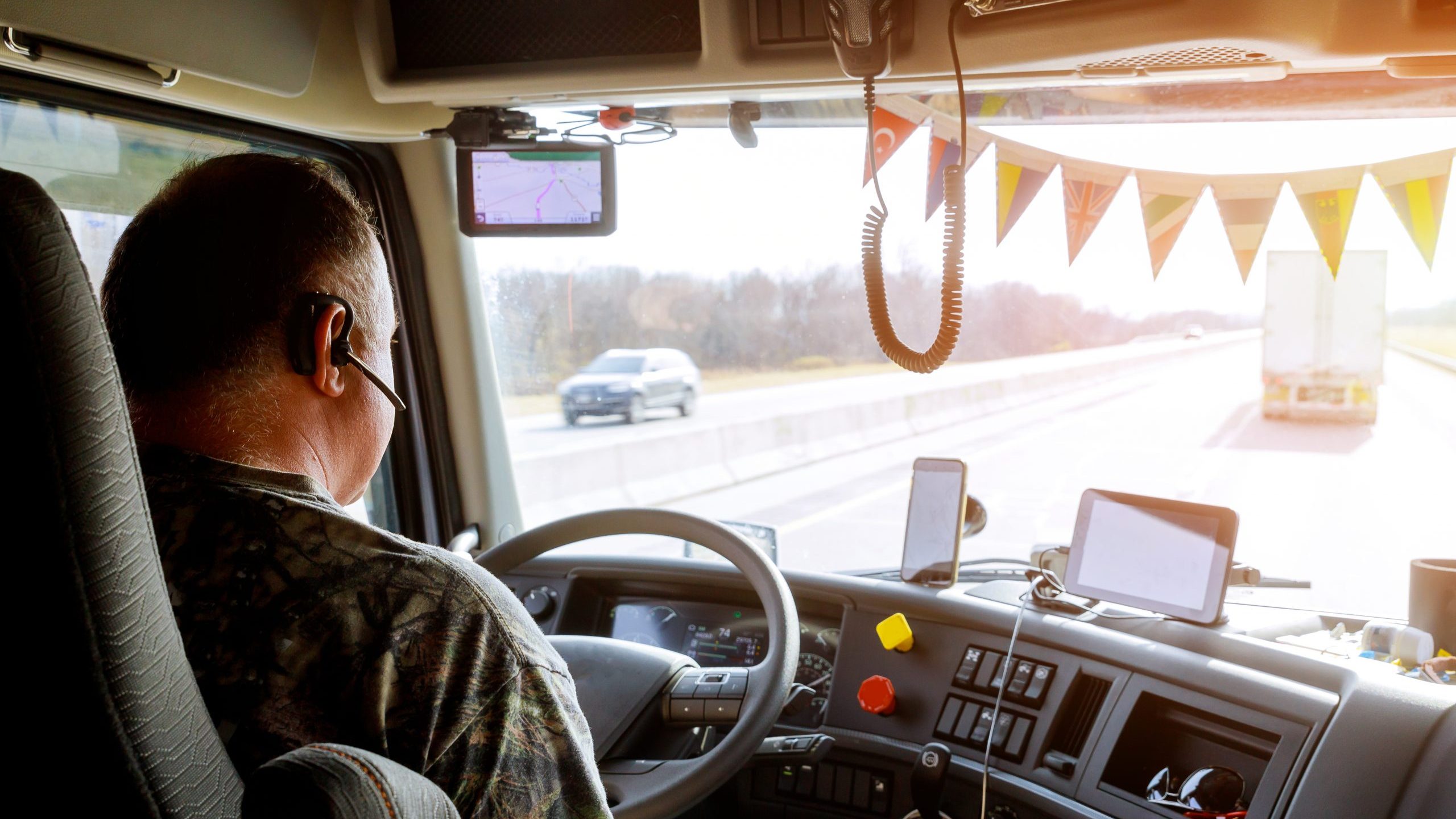 Driver in cabin of truck on highway