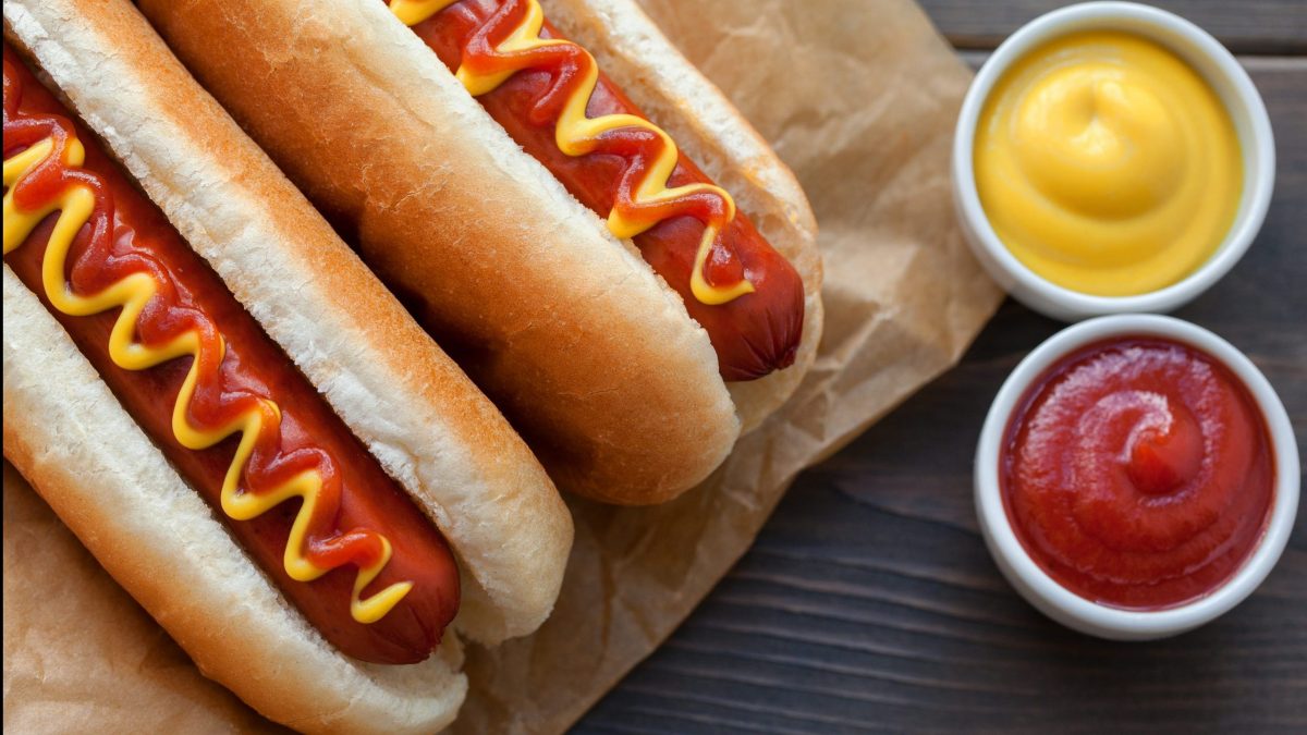 Two hot dogs with ketchup and mustard.