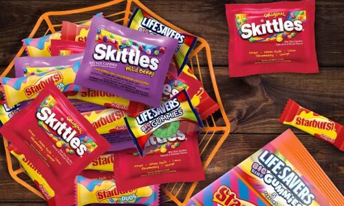 A mixed bowl of Halloween candy, including Skittles and Starburst.