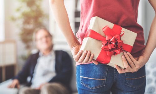 Young daughter gives her father a gift