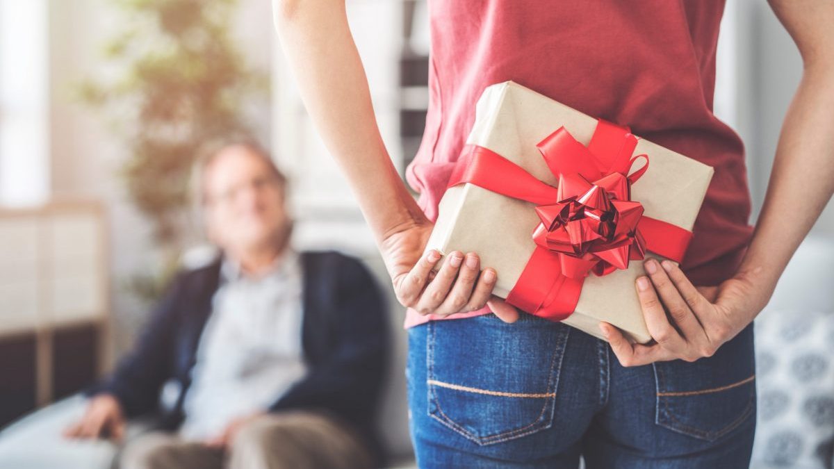 Young daughter gives her father a gift