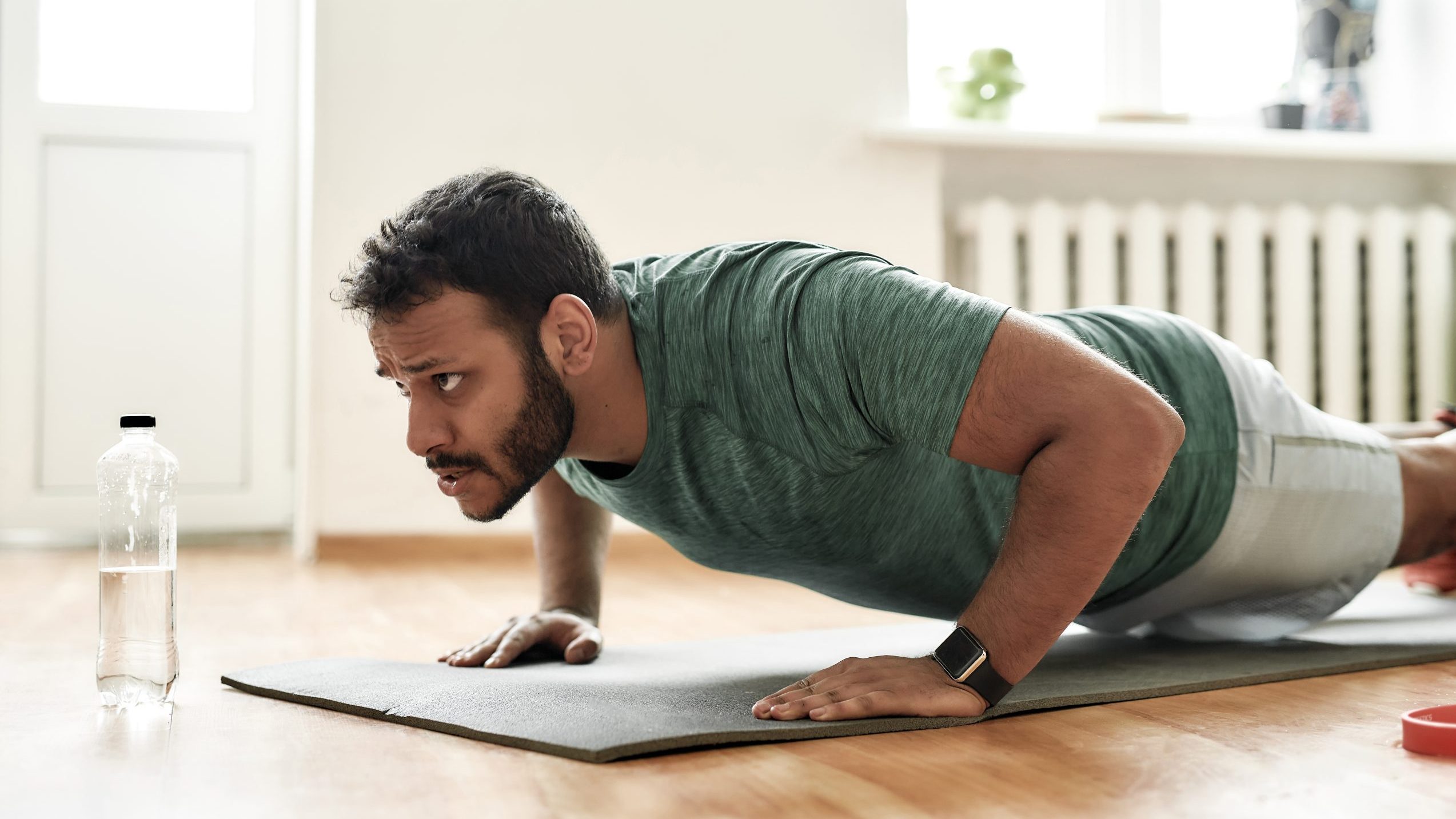 Man performs push-up.