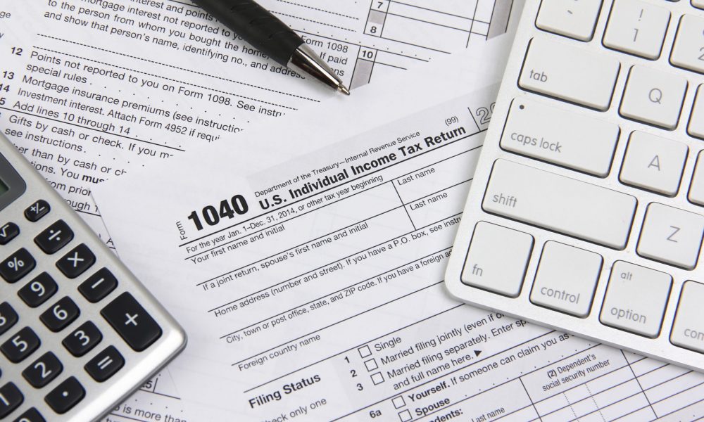 Income tax forms, calculator and computer keyboard