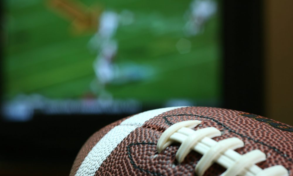 Football in front of TV screen playing game