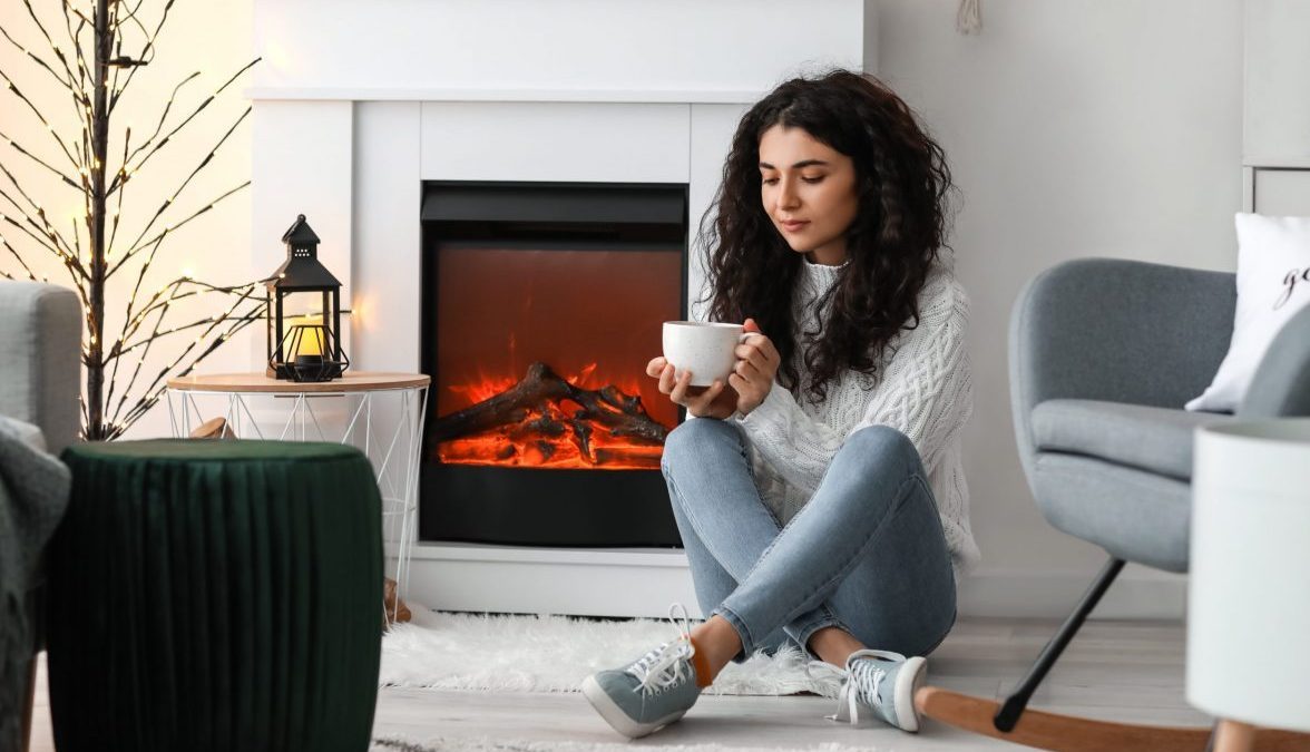 Beautiful woman near fireplace