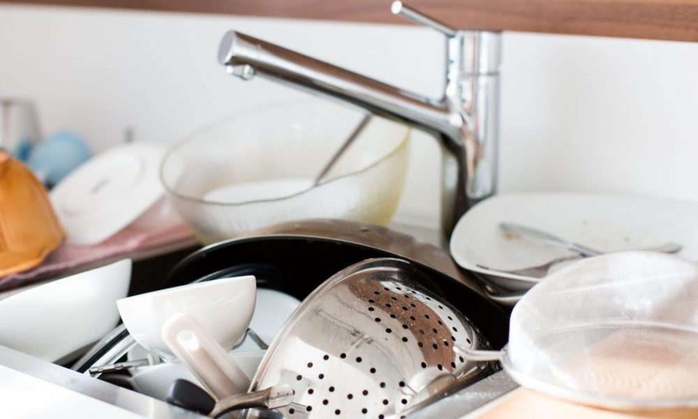 Dirty dishes in the sink to be washed