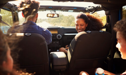 Family inside car on road trip