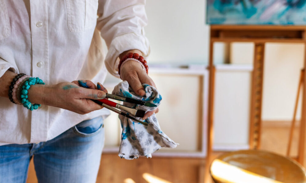 Woman cleaning paintbrush