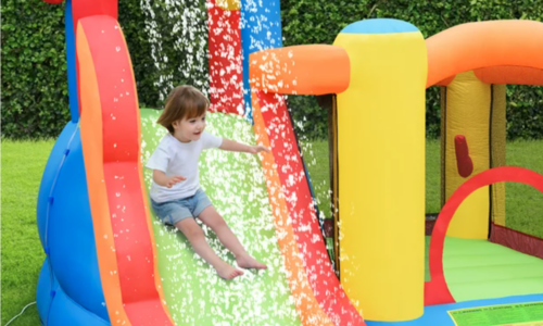 Girl slides on combo bounce house/splash pool