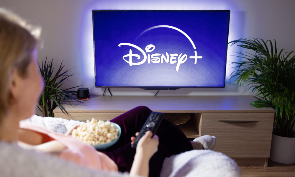 Woman watches Disney+ on TV