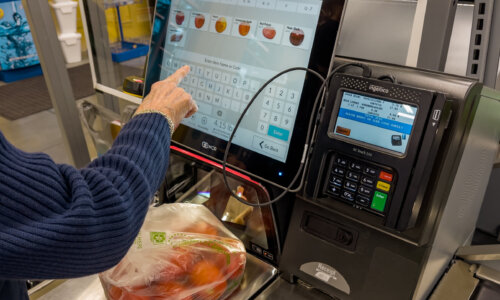 Grocery store customer has produce on self-checkout scale