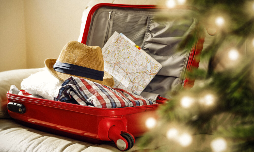 red suitcase and christmas tree decoration