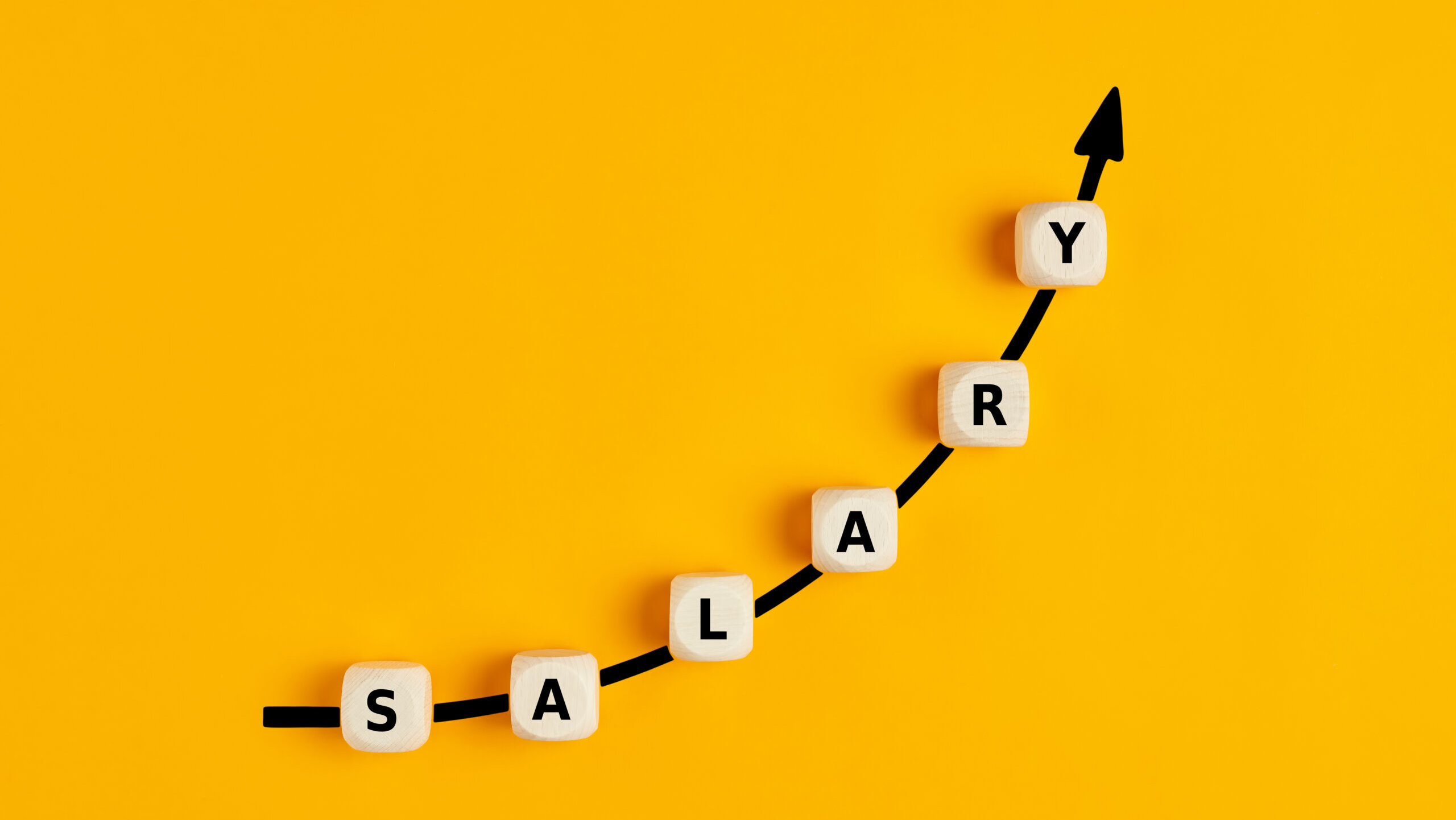 Pay raise concept: Blocks spelling 'salary' rise along arrow on yellow background