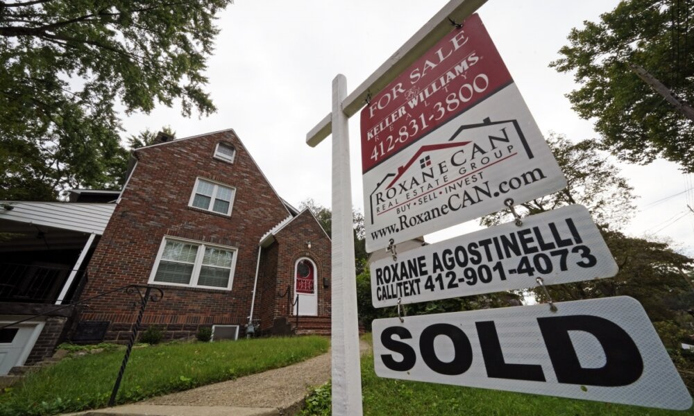 Home with sold sign out front